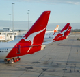 Qantas airplanes lined up at the airport.