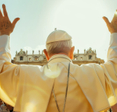 Behind-view of the pope addressing a crowd of people.
