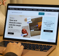 Closeup of laptop with GoDaddy Airo website 