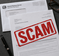 Letter addressed from the IRS with bold red SCAM stamped across it.