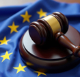 A gavel atop a European Union flag symbolizing EU law and justice