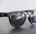 Close-up of black Meta Ray-Ban smart glasses featuring a camera lens.