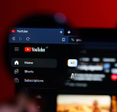 A closeup of a magnifying glass on YouTube desktop