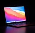 MacBook Air isolated on a desk in the dark.