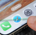Closeup of person tapping Safari icon on smartphone