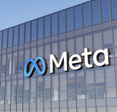 Meta logo on side of glass office building.