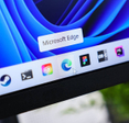 Microsoft Edge browser icon with cursor hovering on taskbar of a modern Windows 11 operating system display, illustrating digital web navigation experience