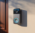Smart video doorbell installed beside residential front entrance door.