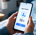 Hands Holding a Smartphone, Pop-Up Age Verification Window with Text is Displayed on Screen.