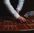 A blackjack table dealer dealing.