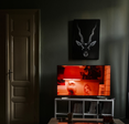 A TV with a red image on the screen, sitting in a dark room.