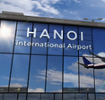 Hanoi International Airport sign on side of building.