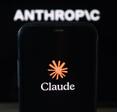 Claude logo on smartphone with Anthropic logo in the background.