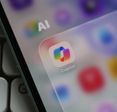 Closeup of a smartphone screen displaying the Microsoft Copilot app icon inside an AI folder.