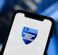 A closeup of a smartphone displaying Prime Video icon with text 'Thursday Night Football'