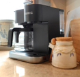 Closeup shot of a coffee station with a Keurig coffee machine in a kitchen.