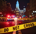 Philadelphia downtown at night building in background with police do not cross tape in foreground