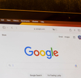 Google's website homepage is seen on a MacBook Air laptop.