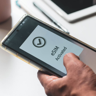 A person's mobile phone displaying "eSIM activated"