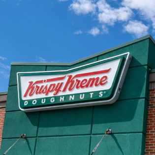 Close up of a Krispy Kreme sign on building