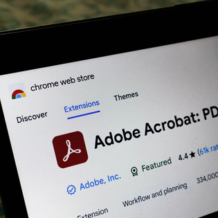 Laptop screen displaying the Adobe Acrobat extension page on the Chrome web store.