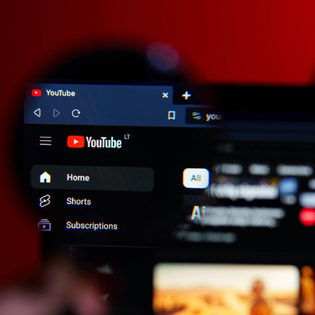 A closeup of a magnifying glass on YouTube desktop