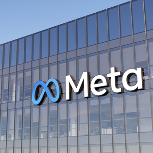 Meta logo on side of glass office building.