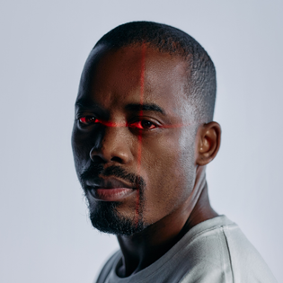 Close up of a man with a laser scan over his eyes.