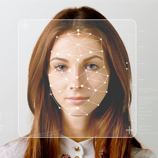 Serious business woman and smart technology for face recognition.