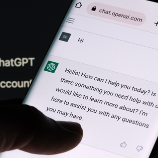 ChatGPT chat bot screen seen on smartphone and laptop display with Chat GPT login screen on the background.