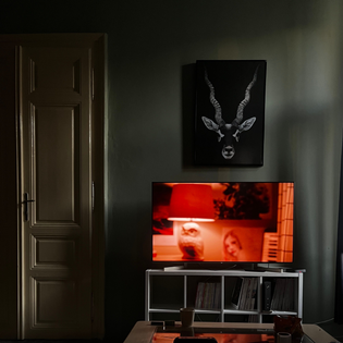 A TV with a red image on the screen, sitting in a dark room.