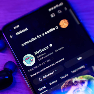 Closeup of smartphone with subscribe page for MrBeast