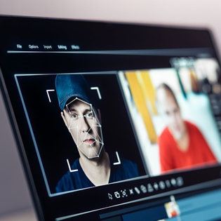 Computer analyzing a man's face and matching it to other photographs of him.