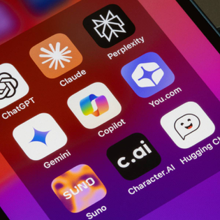 Assorted AI apps are seen on an iPhone, including ChatGPT, Claude, Perplexity, Gemini, Microsoft Copilot, You.com, Suno, Character.AI, and Hugging Chat