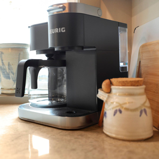 Closeup shot of a coffee station with a Keurig coffee machine in a kitchen.