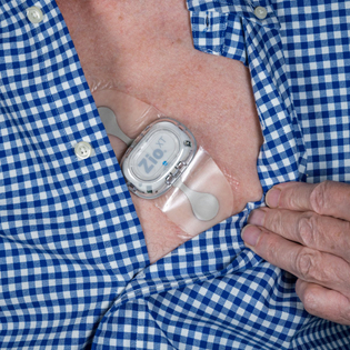 Zio XT adhesive heart ECG monitor on male chest.