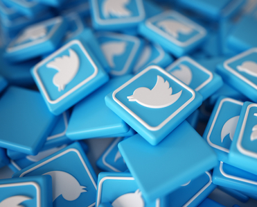 A pile of blue and white Twitter logo chips; Elon Musk plans to charge Twitter users a subscription fee for the verification checkmark on their profile. Here&#x27;s how U.S. adults feel about it.