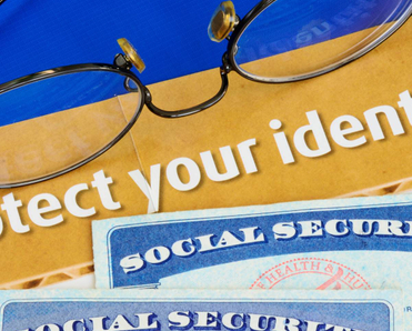 Some text that reads &quot;protect your identity&quot; with two Social Security cards underneath.