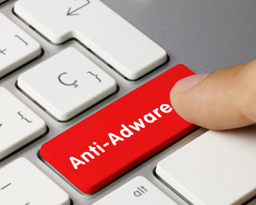 Red keyboard button that says &quot;Anti-Adware&quot; being pressed by finger