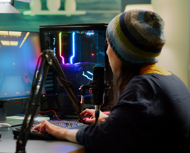 A woman streams on Twitch while playing FPS games and chatting with her subscribers in the chat.
