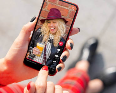 Person holding phone with TikTok content.