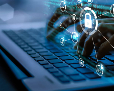 A person typing on a computer with abstract icons for security and other computer features above their hands.