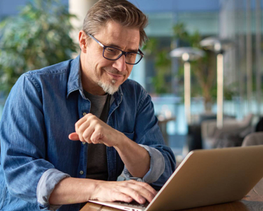 Man at computer in his living room/