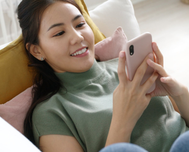 Girl smiling at phone