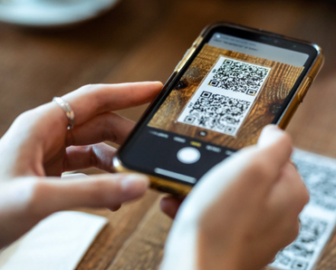 Woman scanning QR code with her phone