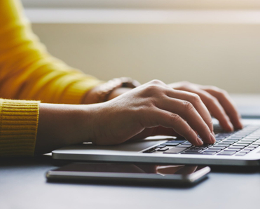 Person typing on laptop
