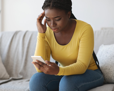Woman looking concerned at her phone