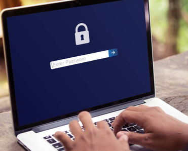 A user logging in to a password protected laptop.