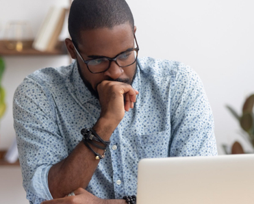 Man looking concerned at laptop