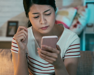 Woman looking skeptically at her phone